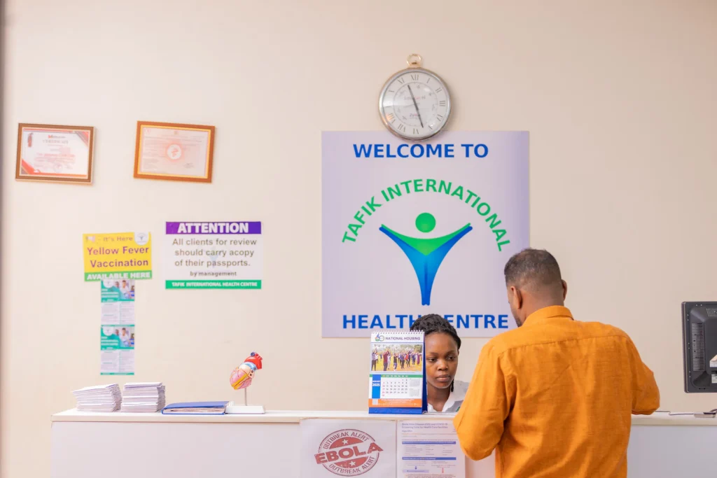 client at reception of medical clinic in kampala