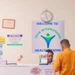 client at reception of medical clinic in kampala